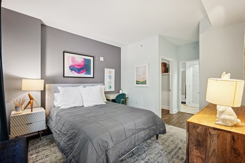 A bedroom with a large bed and a painting on the wall at Yale West, Washington, DC, 20001